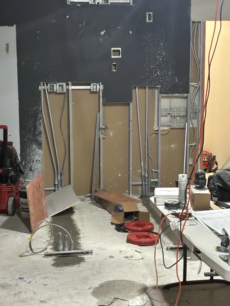 Metal stud wall framing with conduit and electrical boxes set inside